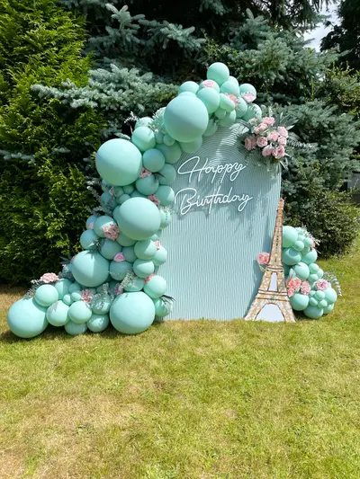 Birthday decor in Leicester by Lulu Belle Events. Paris / French theme. Mint green and blush pink with white. Outdoor garden setting on grass lawn. Rectangular panel with arched upper section.